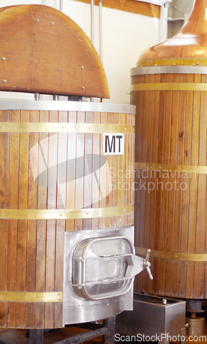 Image of Brewery, machine and barrel for beer, alcohol and brewing process with a tap. Wooden, drum and alcoholic beverage at a distillery for storage, fermentation and manufacturing, industry or system