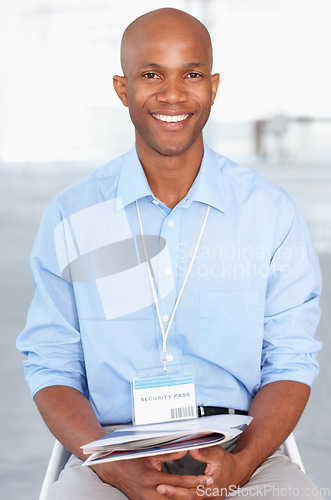 Image of Business, portrait and young black businessman sitting in workshop and conference room at work. Convention, tradeshow and happy African male corporate worker with documents on lap in presentation