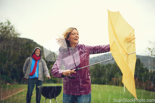 Image of Man, woman and bbq in rain with umbrella, laugh or surprise weather with climate change in garden. Couple, outdoor and funny fail in storm, backyard or cooking in winter with run, wind or hurricane