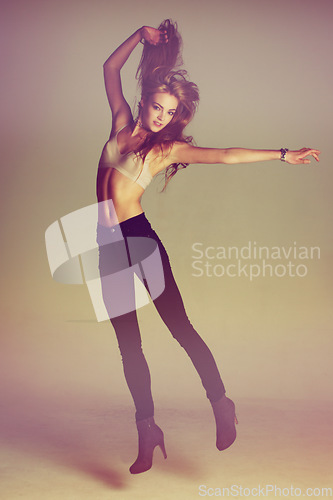 Image of Fashion, dance and jump with portrait of woman in studio for retro, vintage or edgy style. Cosmetics, beauty and confident with female model in jeans isolated on background for sexy, filter and pride