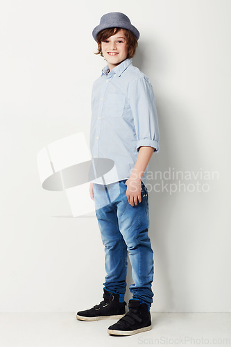 Image of Cool, stylish and portrait of a child in fashion isolated on a white background in a studio. Happy, fashionable and a young boy model in jeans and clothes for style, happiness and confidence