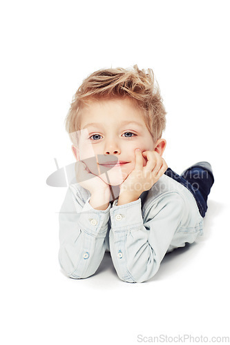 Image of Portrait, smile and boy lying down, relax and cheerful kid isolated against white studio background. Face, male child or young person with happiness, casual and chilling with joy, happy and confident