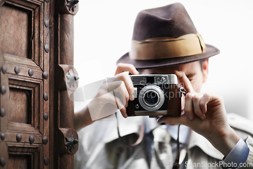 Image of Detective, camera and spy with man in studio for surveillance, reporter and investigation. Photography, press and secret with male agent on white background for vintage, paparazzi and journalist