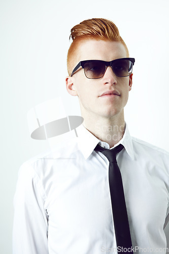Image of Stylish, ginger and a man with sunglasses and thinking while isolated on a white background in a studio. Idea, fashionable and a young employee in professional clothes with eyewear for business
