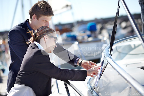 Image of Map, yacht and employees planning travel journey on a boat using paperwork for a luxury vacation or holiday. Teamwork, working and man brainstorming with woman using a document strategy in the ocean