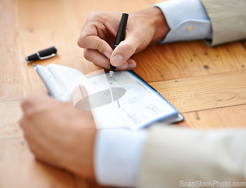 Image of Hands, businessman sign cheque or accountant closeup and signature for consent or confirmation. Finance or payment, money or investment and financial advisor finalising transaction or paperwork