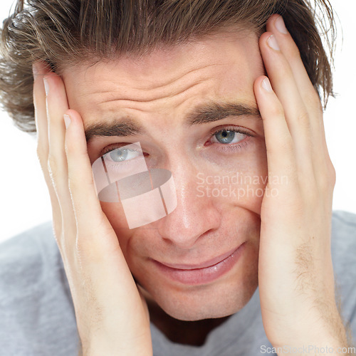 Image of Man, depressed thinking and hands in studio with fear, mental health problem or frustrated by white background. Male model, sad student and anxiety, scared and crying with stress on mind