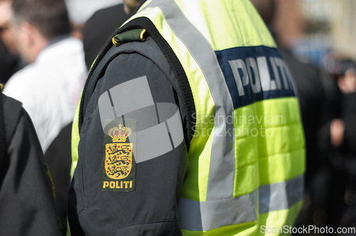 Image of Protest, security and arm of police officer in city for safety, law enforcement and government. Freedom, human rights and politics with person in demonstration rally for movement, march and activism