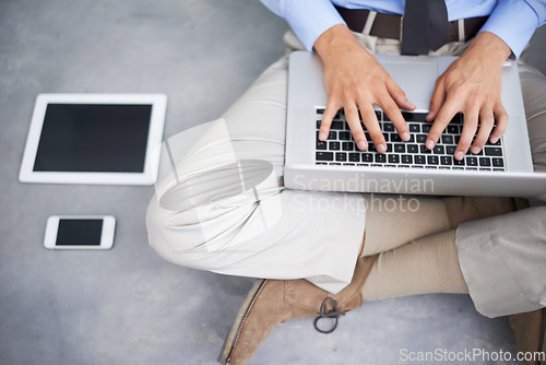 Image of Hands, business man and typing with laptop, cellphone and table for communication, contact or email on floor. Businessman, keyboard and computer for networking, social media or technology in top view