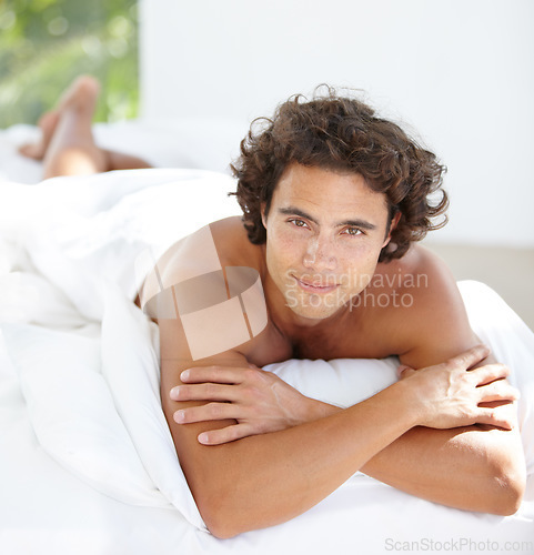 Image of Portrait, smile and man on a bed, relax and chilling on a weekend, break and carefree at home. Face, male person and happy model with happiness, freedom and wellness in a bedroom, calm and peaceful