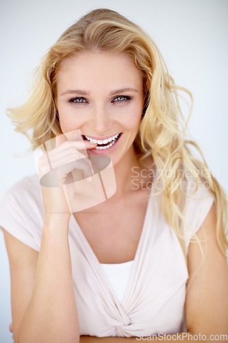 Image of Flirt, portrait and woman biting her finger in a studio with a playful, shy and positive mindset. Happiness, smile and young beautiful female model with seductive pose isolated by a white background.