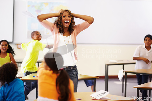 Image of Stress, teacher shouting and black woman in classroom with children running around. Education, headache and female person screaming with burnout, tired or fatigue with kids in busy class at school.