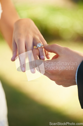 Image of Closeup, wedding and hands with a ring, couple or love ceremony with happiness, commitment or loving. Zoom, groom or bride with engagement event, save the date or jewelry with marriage or partnership