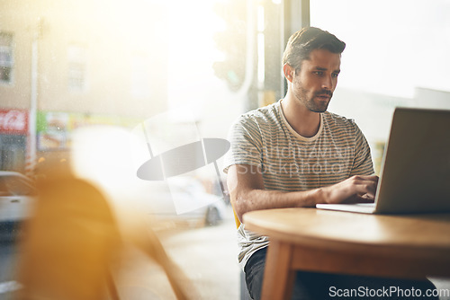 Image of Coffee shop, working and man with laptop and lens flare doing code remote work in a cafe. Tech, email and male freelancer customer at a restaurant and computer writing with focus on web coding