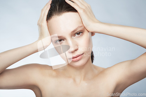 Image of Glow, face portrait and a woman with beauty from skincare isolated on a white background in a studio. Serious, young and a female model for dermatology and cosmetics on a backdrop for care of skin