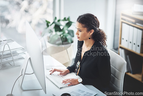 Image of Corporate, typing and a woman with an email on a computer, research or secretary work. Analytics, desk and a female receptionist with a pc in an office for communication, connectivity and working