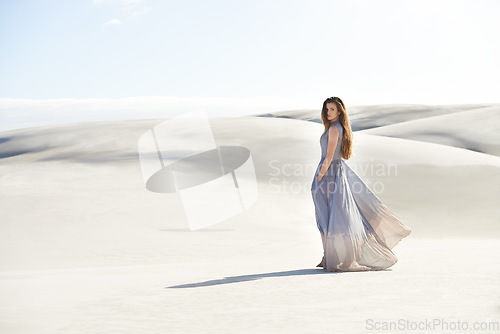 Image of Fashion, dress of woman in the desert and wind isolated around sand. Travel or freedom, holiday or vacation and female person and portrait of goddess on adventure with mockup space outdoor in summer