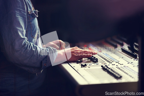 Image of Closeup, hands and sound engineer with a mixing desk, music and artist recording with equipment. Fingers, creative and musician with automatic equalizer, professional and buttons for songs and sounds