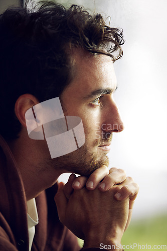 Image of Thinking, sad and a man looking depressed with a mental health problem, depression or anxiety. Fail, young and a guy sitting with thoughts of worry, stress and unhappy in a house, lonely and grieving