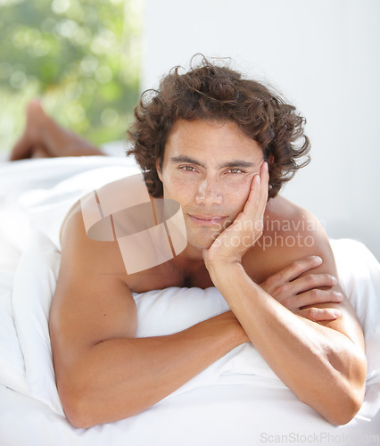 Image of Relax, portrait and a man in bed in the morning for rest, relaxation and content. Sexy, calm and a young guy lying in the bedroom with peace, stress relief and relaxing on the weekend at home