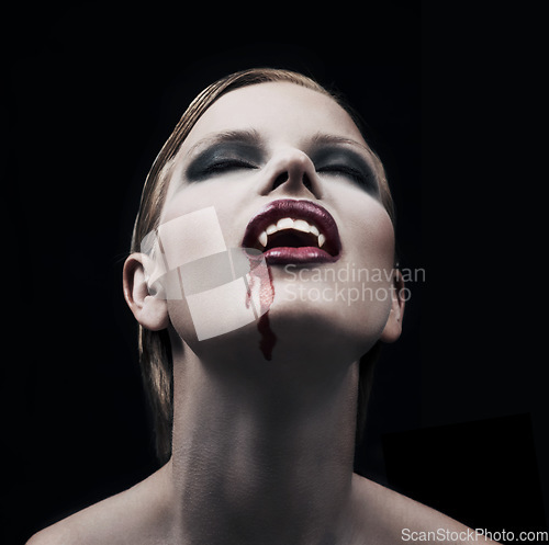 Image of Blood, woman and vampire with fantasy, fangs and lady against a dark studio background. Female person, supernatural being and girl mystic, aesthetic and monster with creativity, demon and character