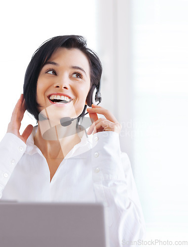 Image of Call center, customer support and happy woman doing online consultation in the office. Contact us, smile and female telemarketing representative, agent or consultant working with headset in workplace