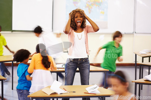 Image of Stress, teacher screaming and black woman in classroom with children running around. Education, headache and female person shouting with burnout, tired or fatigue with kids in busy class at school.