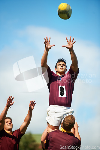 Image of Sports, rugby player catch and with ball on field of grass. Teamwork or collaboration, professional athlete and strong athletic men or fitness people together as a team in sportswear or gear