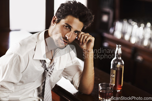 Image of Business man, drinking and portrait in happy hour at a bar with alcohol and whiskey after work. Bottle, male person and face in a restaurant with a playboy guy and a glass and confidence in pub