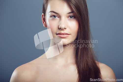 Image of Skin, beauty and face portrait of a woman in studio with natural makeup and cosmetics. Headshot of aesthetic gen z female model on a grey background for glow, hair care and facial dermatology shine