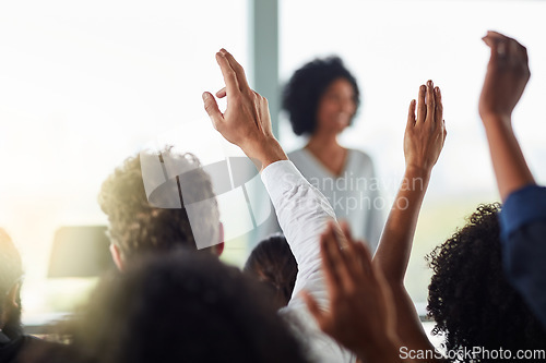 Image of Back, business people and hands raised for questions at conference, seminar or meeting. Group, audience and hand up for question, asking or answer, crowd vote and training at workshop presentation.