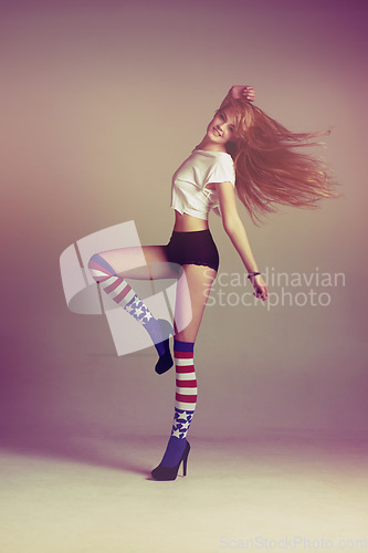 Image of Portrait of woman with socks, fashion and energy in retro art style on studio background with American flag. Beauty, underwear and carefree, sexy influencer model jumping in vintage fun mockup space.