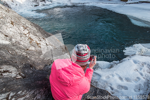 Image of Happy woman relaxing on the top of mountain