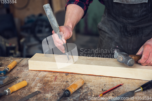 Image of Carpenter working with a chisel