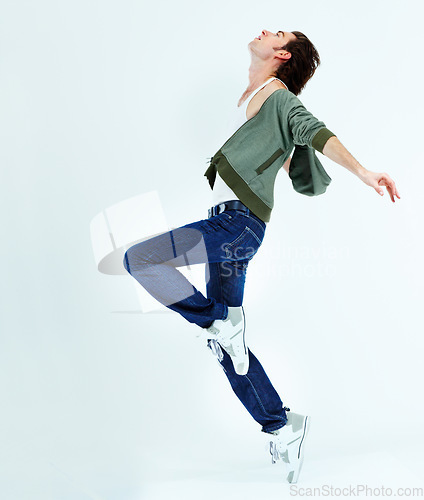 Image of Man, jump and dance in the air for happiness with action, movement and balance of body isolated on white studio background. Male ballet dancer, happy and free with energy or dancing to music for fun