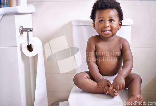 Image of African baby boy, toilet and home with smile, learning and childhood development for potty training. Young toddler, black child or kid sitting in bathroom with diaper, growth and looking in house