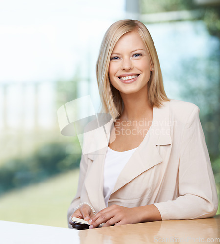 Image of Business woman, portrait and smile in office with confidence, motivation and excited for entrepreneurship. Young businesswoman, entrepreneur and happy in workplace for startup management at desk