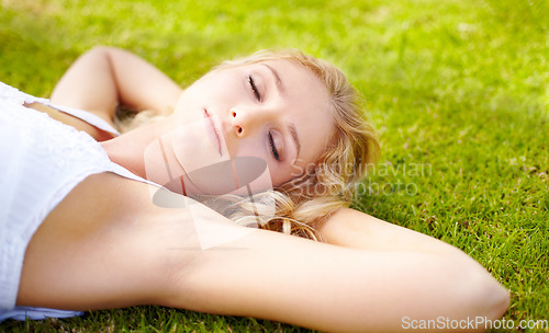 Image of Relax, zen and a woman sleeping on grass outdoor in nature during summer for peace or quiet on a field. Spring, garden and freedom with an attractive young person relaxing outside in the countryside