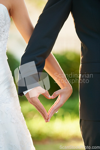 Image of Hands, bride and groom heart sign at wedding, celebration or vow ceremony and love, couple and marriage. Man, wife and commitment together and care, unity and promise for relationship happiness