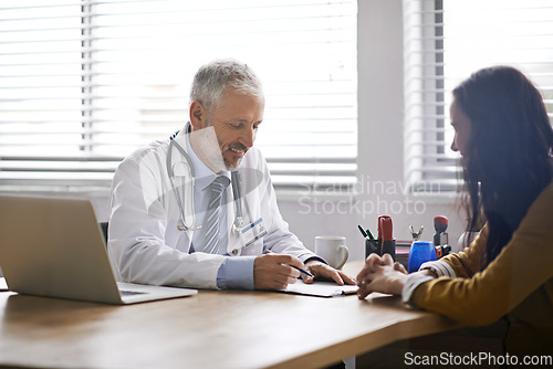 Image of Doctor, paperwork and talking to a woman patient at hospital for a consultation or health insurance. A man listening to a happy female person in office for signature consent, support or medical help