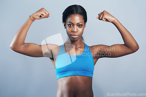 Image of Power, fitness and portrait of black woman flexing arm muscles for exercise motivation and strong body. Health, wellness and strength, female bodybuilder sports model in arm flex on studio background