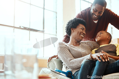 Image of Happy, love and family bonding on a sofa together in the living room of their modern house. Happiness, smile and African parents spending quality time, talking and relaxing with her boy child at home