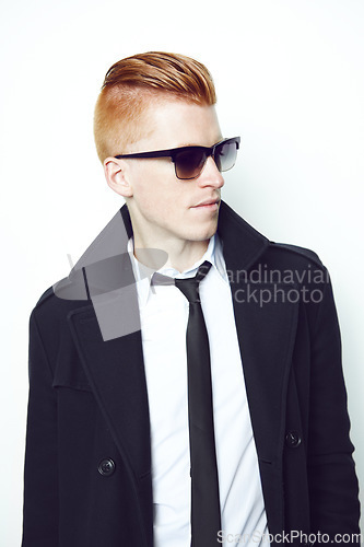 Image of Fashion, cool and man in a suit in a studio with sunglasses and a stylish formal outfit. Young, cool and handsome male model with elegant trendy style and confidence isolated by a white background.