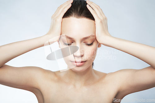 Image of Woman, beauty and hands on head for hair care, skincare or cosmetics treatment on gray studio background. Girl, face and closed eyes to relax at spa for scalp, body and facial massage or selfcare