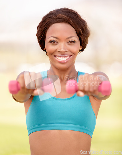 Image of African woman, dumbbell and outdoor portrait with smile, exercise and commitment with self care, Girl, training and fitness in park, garden or backyard for workout, wellness and health in lifestyle