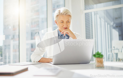 Image of Laptop, thinking and senior business woman in office inspired by research, idea and mission plan. Online, project and happy elderly female manager inspired while typing, browsing or planning proposal