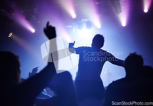 Image of Rock concert, dance and party crowd with disco lighting and people back with dancing. Silhouette, audience and night festival event with performance and group listening and watching a band music