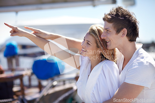 Image of Happy, travel and couple point on yacht with smile on summer holiday, vacation and adventure on ocean. Love, travelling and man and woman pointing on luxury cruise for journey, romantic trip and fun