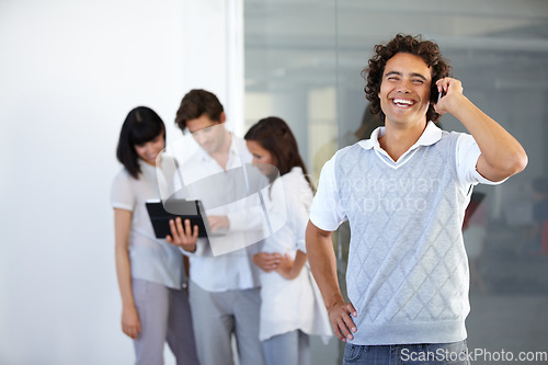 Image of Phone call, office and happy business man with team in conversation, discussion and networking. Communication, corporate and male worker on cellphone talking, speaking and connection in workplace