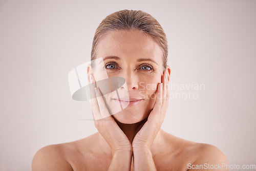 Image of Portrait, senior woman and face for cosmetic wellness or touching her perfect skin or isolated and on grey background. Mature lady, massaging wrinkles and facial aging or dermatology and skincare